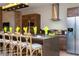 Modern kitchen with stainless steel appliances and an island with seating at 7527 Brooklyn Dr # 7527, Kissimmee, FL 34747