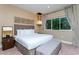 King-size bed, plush ottoman and modern decor at 7527 Brooklyn Dr # 7527, Kissimmee, FL 34747