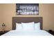 King-size bed, neutral tones and modern artwork at 7527 Brooklyn Dr # 7527, Kissimmee, FL 34747