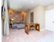 Bright bonus room with a comfy couch, work desk, and large wall art at 7527 Brooklyn Dr # 7527, Kissimmee, FL 34747
