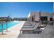 Community pool with plenty of lounge chairs and umbrellas at 7527 Brooklyn Dr # 7527, Kissimmee, FL 34747