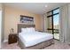 King-size bed, large window with city view, and stylish decor at 7527 Brooklyn Dr # 7527, Kissimmee, FL 34747