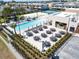 Community pool area with tables and chairs for relaxing at 7527 Brooklyn Dr # 7527, Kissimmee, FL 34747