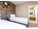 Two twin beds, wood wall, and ensuite bathroom at 7527 Brooklyn Dr # 7527, Kissimmee, FL 34747