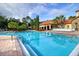 Inviting pool area with lounge chairs and building view at 8020 Tuscany Way # 6103, Davenport, FL 33896