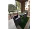Screened-in patio with wicker furniture and artificial turf at 8020 Tuscany Way # 6103, Davenport, FL 33896