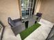 Screened-in patio with wicker furniture and artificial turf at 8020 Tuscany Way # 6103, Davenport, FL 33896