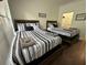Guest bedroom with two twin beds and wood floors at 8020 Tuscany Way # 6103, Davenport, FL 33896