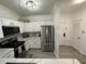 Modern kitchen with white cabinets and stainless steel appliances at 8020 Tuscany Way # 6103, Davenport, FL 33896