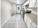 Modern kitchen with white cabinets and tile floors at 220 Cherokee Ct # 107, Altamonte Springs, FL 32701