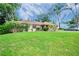 Brick house with a well-maintained lawn and a tranquil neighborhood at 5924 White Egret Ln, Orlando, FL 32810