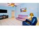Bright living room featuring a comfy sofa and large TV at 5924 White Egret Ln, Orlando, FL 32810