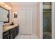 Bathroom with granite countertop vanity, dark wood cabinets, and shower at 5924 White Egret Ln, Orlando, FL 32810