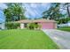 Ranch style home with a pink garage door at 5924 White Egret Ln, Orlando, FL 32810