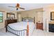 Spacious bedroom with wood furniture and ceiling fan at 5924 White Egret Ln, Orlando, FL 32810