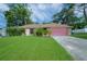 Brick ranch home with pink garage door at 5924 White Egret Ln, Orlando, FL 32810