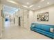 Bright hallway with light colored tile floors and a blue couch at 2476 Pine Preserve Ct, St Cloud, FL 34771