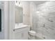 Modern bathroom with white vanity, shower, and marble tile at 2476 Pine Preserve Ct, St Cloud, FL 34771