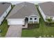 One-story home with grey roof, paver driveway, and landscaped yard at 2476 Pine Preserve Ct, St Cloud, FL 34771