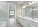 Elegant bathroom with double vanity and large mirror at 2476 Pine Preserve Ct, St Cloud, FL 34771