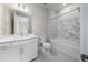 Updated bathroom featuring a bathtub, white vanity, and marble-style shower at 2476 Pine Preserve Ct, St Cloud, FL 34771