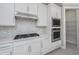 Modern kitchen with white cabinets, gas cooktop, and built-in microwave at 2476 Pine Preserve Ct, St Cloud, FL 34771