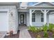 Front entry with stone accents, a modern door, and a covered porch at 2476 Pine Preserve Ct, St Cloud, FL 34771