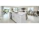 Open concept kitchen with white cabinets and a large island overlooking the living room at 2476 Pine Preserve Ct, St Cloud, FL 34771