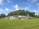 Entrance to Del Webb Sunbridge with a fountain and palm trees at 2476 Pine Preserve Ct, St Cloud, FL 34771