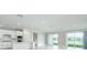 Modern kitchen with white cabinets, island, and stainless steel appliances at 2476 Pine Preserve Ct, St Cloud, FL 34771