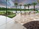 Relaxing outdoor kitchen and patio area with a pond view at 2476 Pine Preserve Ct, St Cloud, FL 34771