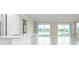 Bright living room with a view of a lake from sliding glass doors at 2476 Pine Preserve Ct, St Cloud, FL 34771