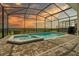 Screened-in pool and spa with sunset view at 1697 Kona Ln, Davenport, FL 33897