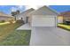 Single-story home with a two-car garage and driveway at 1078 Osprey Cove Cir, Groveland, FL 34736