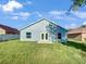 House exterior with grassy backyard at 1078 Osprey Cove Cir, Groveland, FL 34736