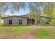 Ranch style home with stone facade, landscaping, and a spacious lawn at 1521 Oxford Rd, Maitland, FL 32751