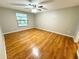Spacious bedroom with wood-look flooring and large window at 7817 Satsuma Ct, Orlando, FL 32835