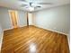 Bright bedroom featuring wood-look floors and access to bathroom at 7817 Satsuma Ct, Orlando, FL 32835