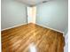 Bedroom with wood-look floors and access to bathroom at 7817 Satsuma Ct, Orlando, FL 32835