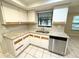 Kitchen with white cabinets, granite countertops, and stainless steel dishwasher at 7817 Satsuma Ct, Orlando, FL 32835