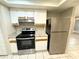 Modern kitchen features stainless steel appliances and granite countertops at 7817 Satsuma Ct, Orlando, FL 32835