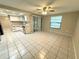 Bright living room with tile floors and kitchen access at 7817 Satsuma Ct, Orlando, FL 32835