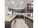 Modern kitchen with granite countertops and dark brown cabinetry at 2031 Lelani Cir, Davenport, FL 33897