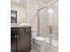 Bathroom with shower, toilet and dark brown vanity at 2031 Lelani Cir, Davenport, FL 33897