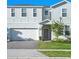 Two story home with white siding and gray door at 2031 Lelani Cir, Davenport, FL 33897