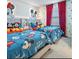Mickey Mouse themed bedroom with twin beds and vibrant decor at 2031 Lelani Cir, Davenport, FL 33897
