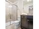 Clean bathroom with shower, toilet and dark vanity at 2031 Lelani Cir, Davenport, FL 33897