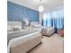 Two twin beds with matching bedding in a bright bedroom at 2031 Lelani Cir, Davenport, FL 33897