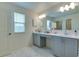 Elegant bathroom with double vanity, marble flooring, and large mirror at 14007 Creek Harbor Dr, Orlando, FL 32824