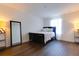 Bedroom with a queen bed, full length mirror and dark wood floors at 14007 Creek Harbor Dr, Orlando, FL 32824